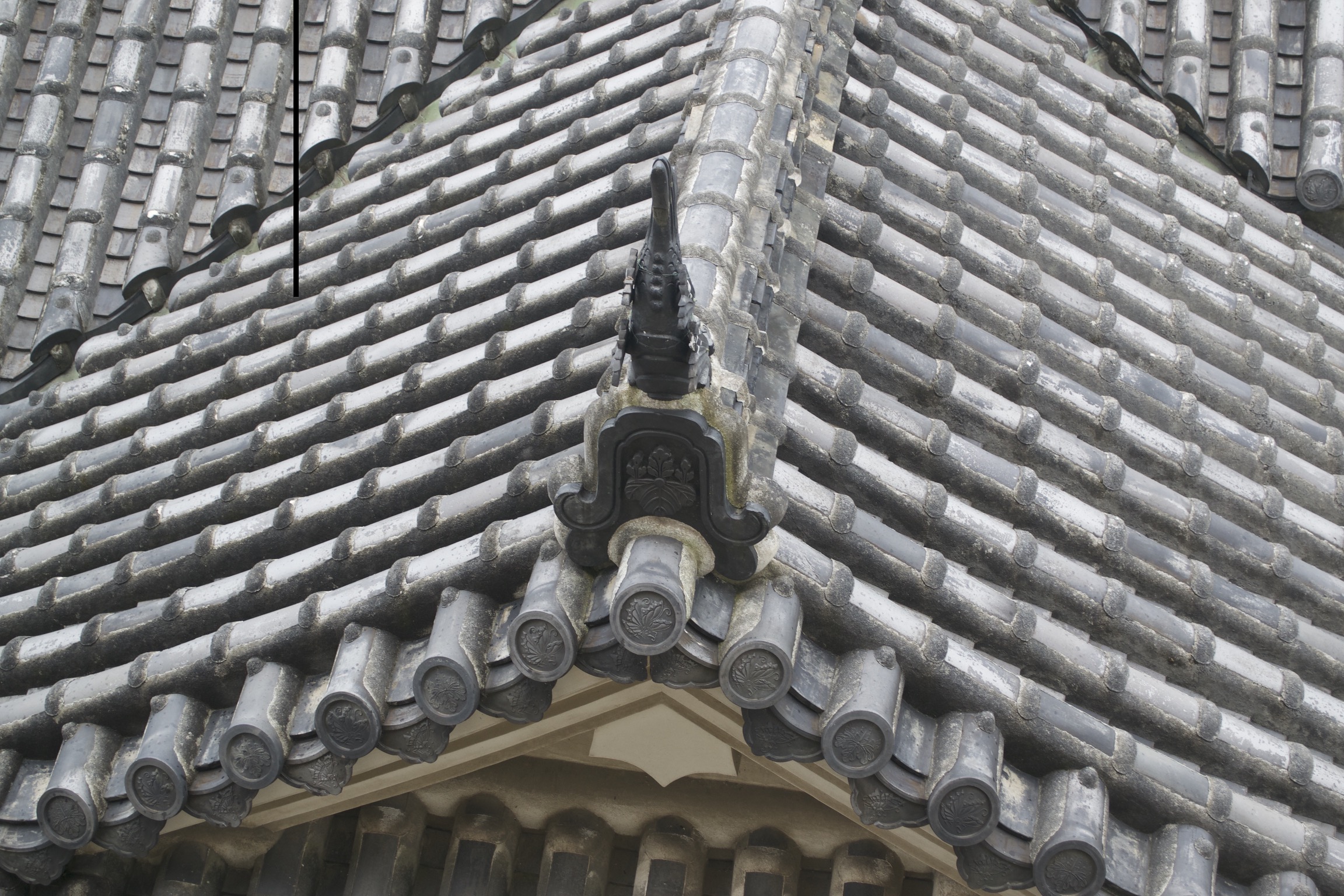 Hand-made cylindrical cermaic tiles cover a roof.