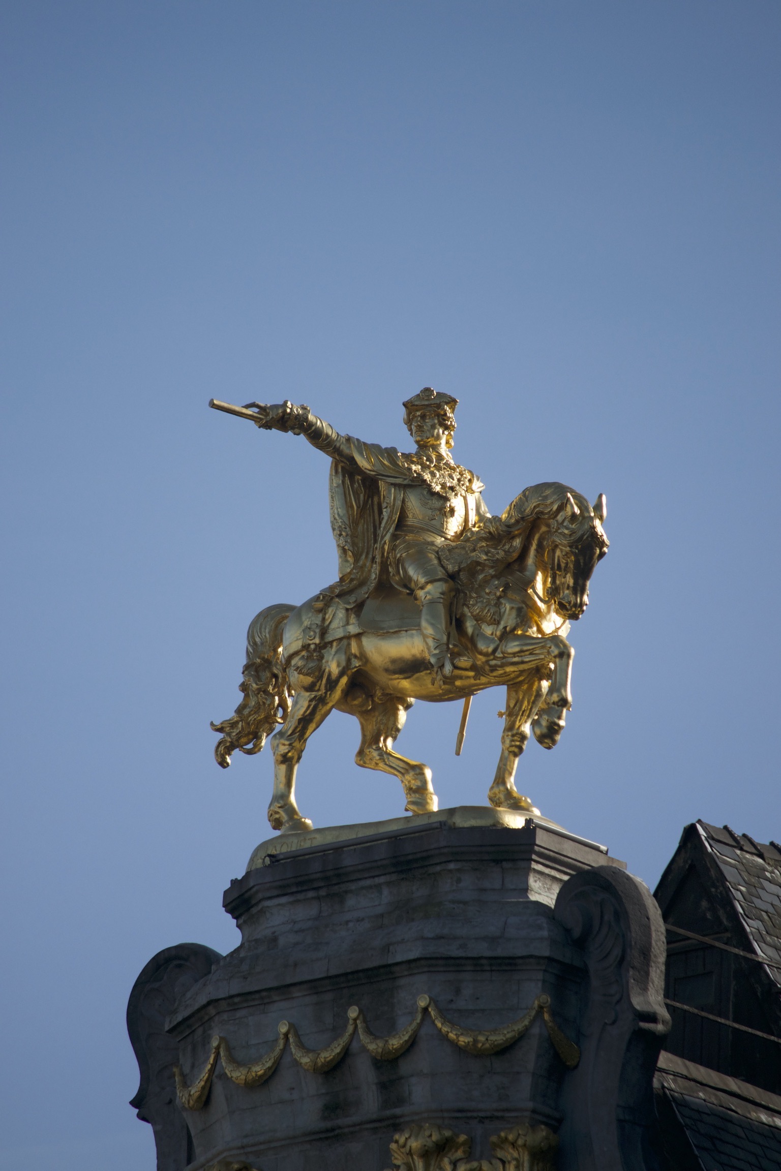 A golden statue of a man on a horse.