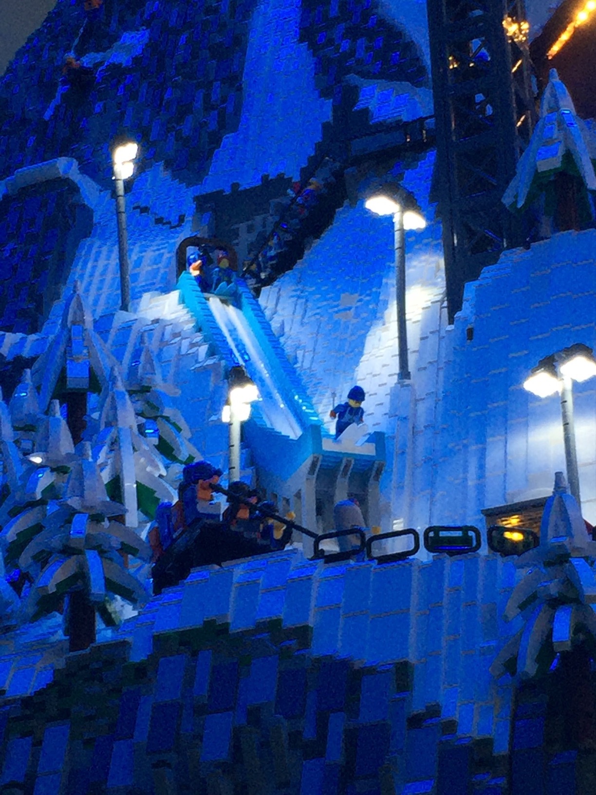 A LEGO skier about to take off from a ski jump.
